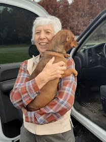 woman holding a dachshund