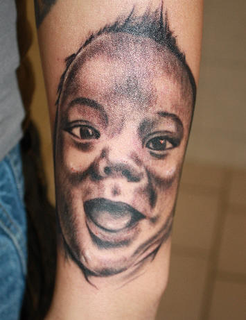 Happy baby tattoo.