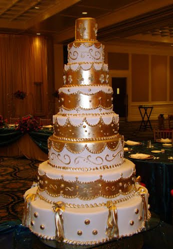 Decadent multitiered wedding cake in white and gold