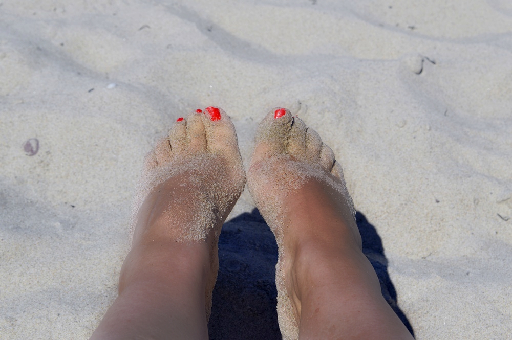 barfoot in the sand, on the beach in warnemuende, warm sand