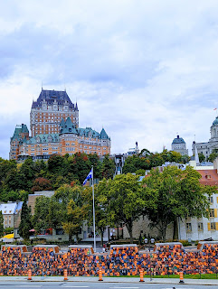 A view Fairmont Le Château Frontenac in Quebec City in the background with a wall of life-preservers in the foreground