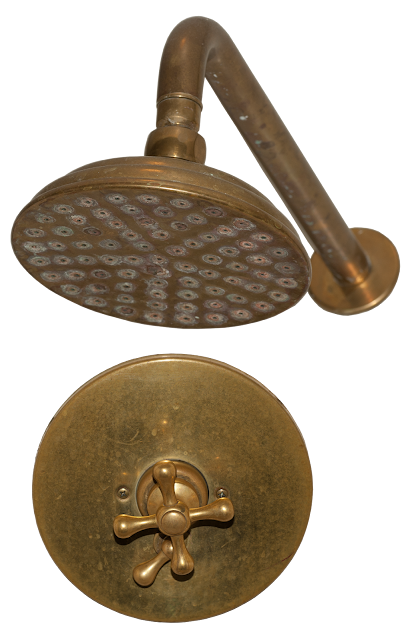 A large shower head with fittings and water handle in brass, tarnished with age.