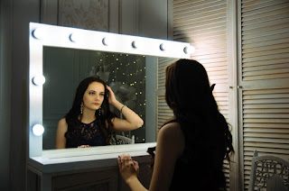 brunette looking into a mirror