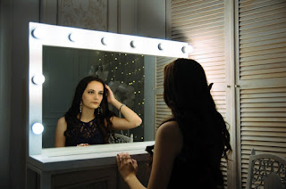 brunette looking into a mirror