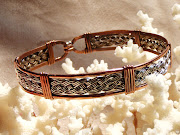 While wearing his jewelry creations, hand tooled silver and copper bracelets .