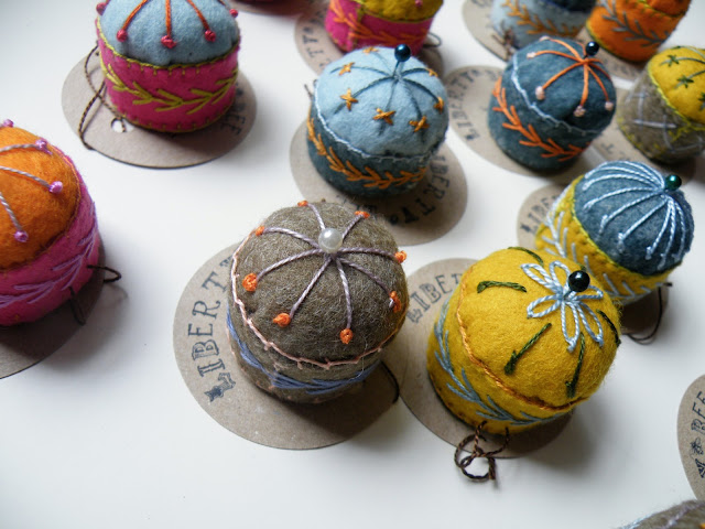 hand embroidered felt pincushions made from wine screw caps, wadding and felt 