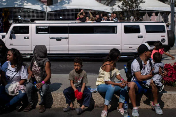 Members of the migrant caravan from Central America are sitting in Paseo de la Reforma as part of the International Migrants Day commemoration on December 18, 2021 in Mexico City, Mexico. US bound migrants of a caravan that arrived to Mexico City this week will participate in events to commemorate the International Migrants Day.