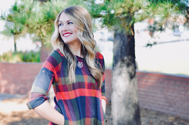 young blonde woman smiling over her shoulder