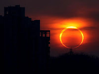 2012 annular solar eclipse seen at sunset near buildings