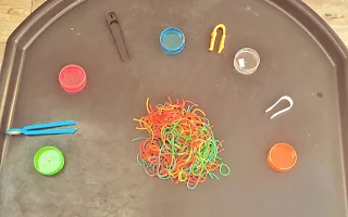 Rainbow spaghetti on a tuff tray