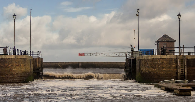 Photo of water pouring over the closed marina gate