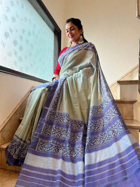 Greenish white body with mauve border and pallu cotton patola saree