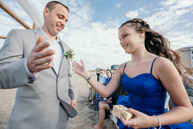 Groom high fiving Bridesmaid on entrance into ceremony