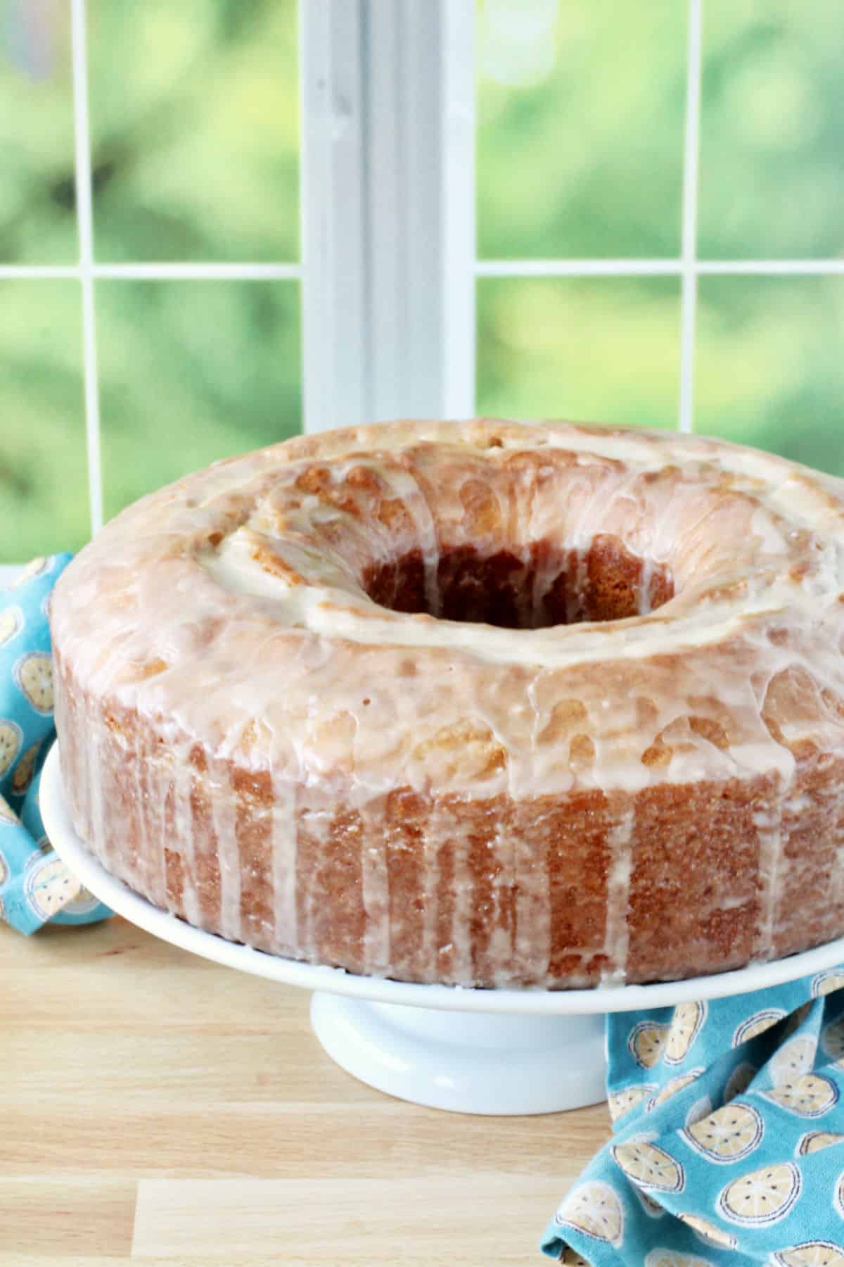 Glazed Tangerine Donut Cake on a cake pan.