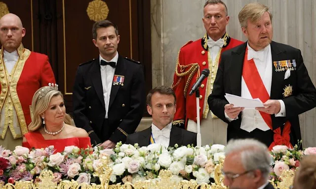 Queen Maxima wore a new red satin dress by Claes Iversen. President Emmanuel Macron and Brigitte Macron