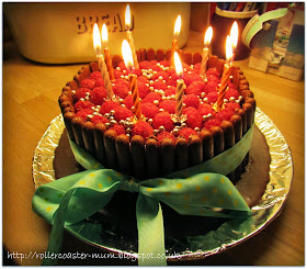 Birthday cake with chocolate fingers and raspberries