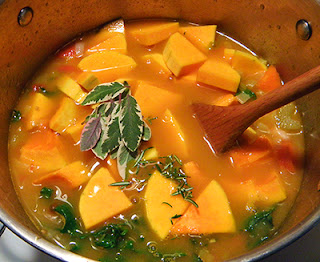 Pot of Soup with Squash and Herbs on top