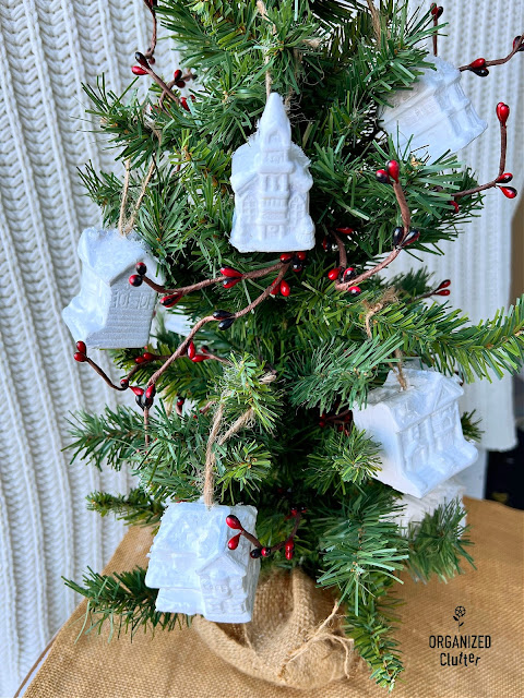 Photo of thrifted Christmas Snow Village ornaments painted white with faux snow.
