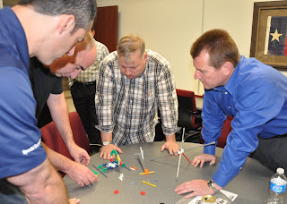 Law enforcement officers test the dirty dozen of human error in a timed exercise building a model helicopter.