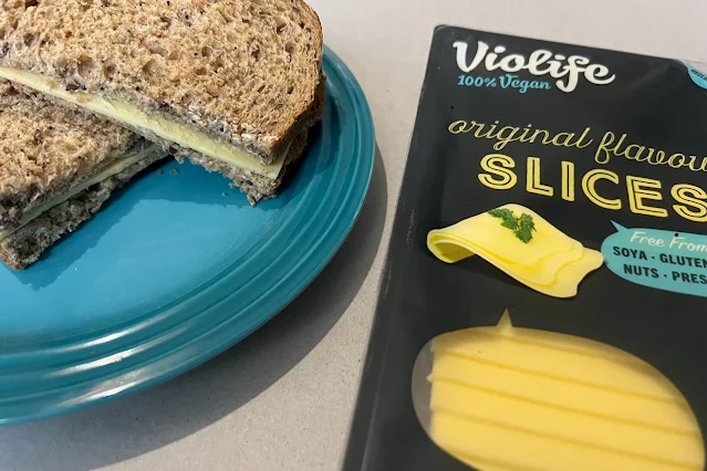 A packet of Violife original sliced cheese in a sandwich