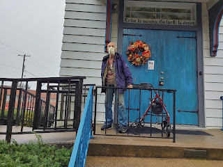 Freshly-painted blue door with a man standing in front