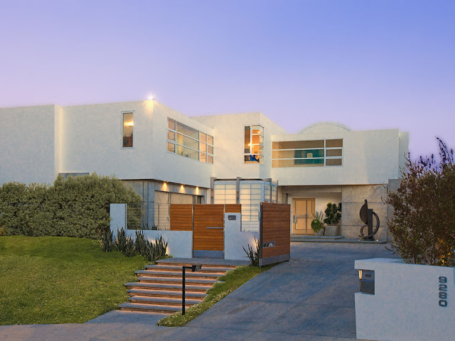Picture of modern mansion as seen from the street at sunset