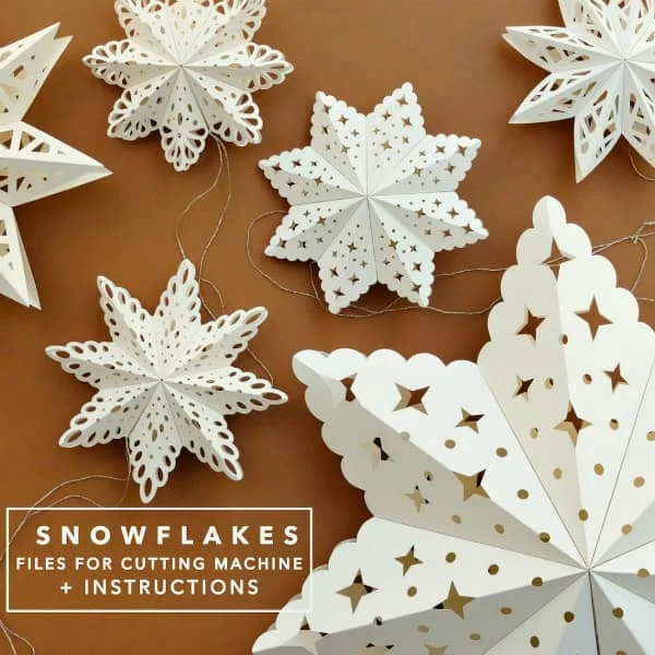 display of white, folded paper cut snowflakes