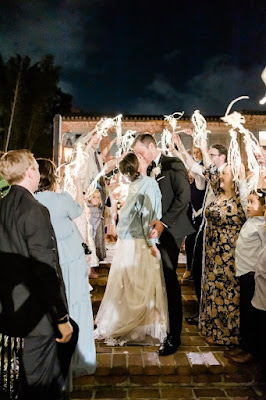 bride and groom kissing in white streamers