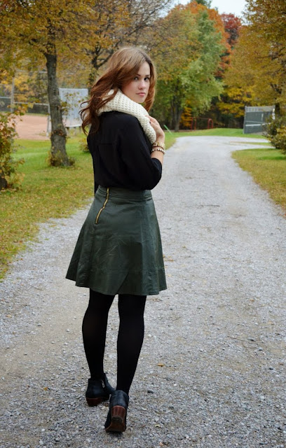 Leather skirt with black shirt and cream scarf