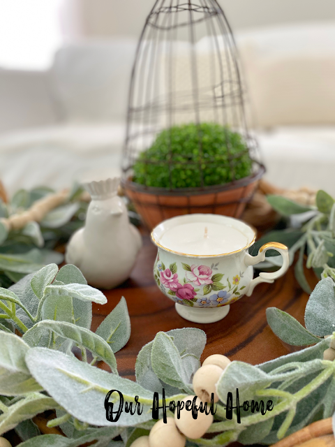 spring coffee table vignette with tea cup candle