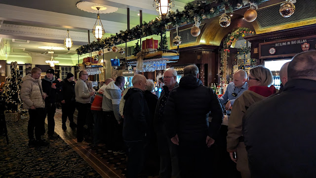 People standing at a bar in Wales.