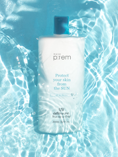 bottle of make p:rem uv protection suncream in a sunny blue water