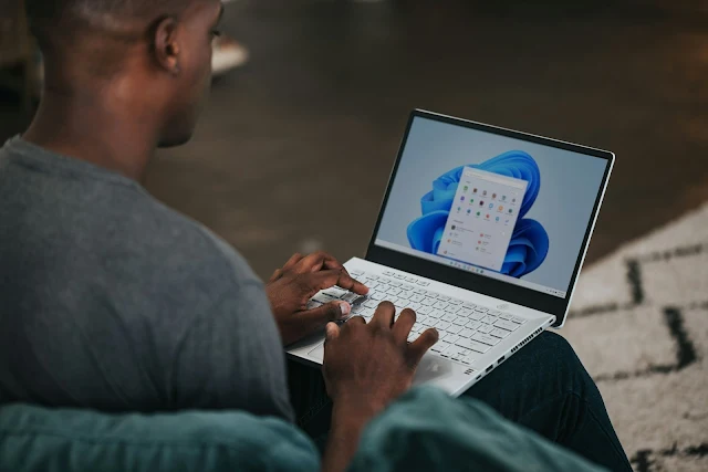 a man using a Windows 11 laptop