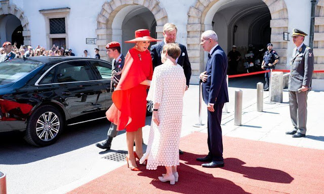 Queen Maxima wore a new Jamba half-long draped silk crepe red dress by Natan. Diamond and pearl drop brooch