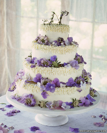  colored round four tier wedding cake with and array of pretty purple 