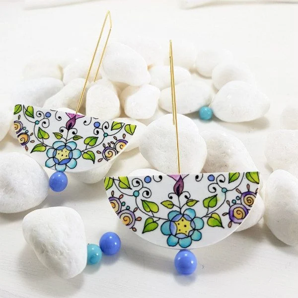 pair of dangling earrings with hand-painted floral design and glass pearls