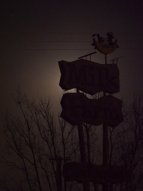 Milk Farm Sign backlit by moon and front lit by CHP