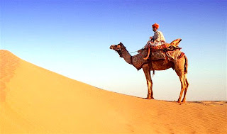 A camel rider in a Pakistani desert