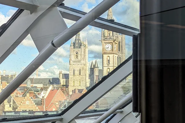 One day in Ghent: View of the three medieval towers through the glass roof of the Marriott Ghent