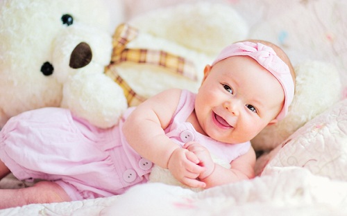 Cute Baby Girl Playing with Teddy Bear