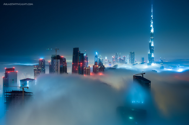 Photo of skyscrapers in Downtown Dubai at night above the fog