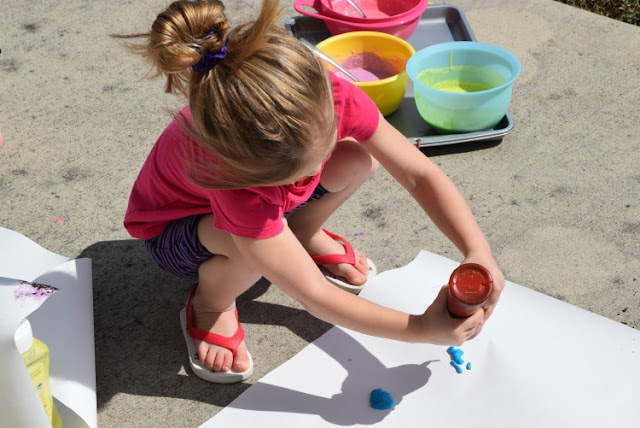 Squirt! Drip! Pour! Process Art Painting For Kids.  Head outside for some messy painting fun for spring our summer.  Preschoolers, kindergartners, and elementary students will LOVE this opportunity to make giant process art.