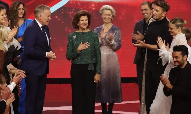 Queen Silvia wore a green sequin sweater, top by Georg et Arend, and black trousers, and Chanel leather shoes