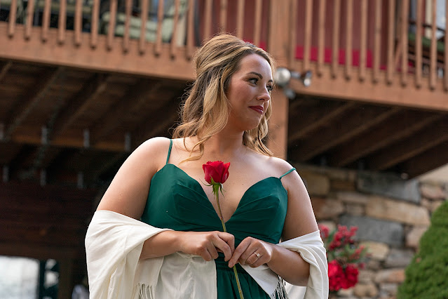 Bridesmaid in emerald dress with a red rose in hand Magnolia Farm Asheville Wedding Photography captured by Houghton Photography