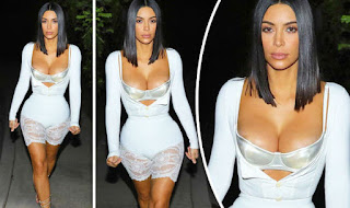 Kim Kardashian in balconette bra as outerwear under blue coat creating overflowing boobs effects with huge cleavage