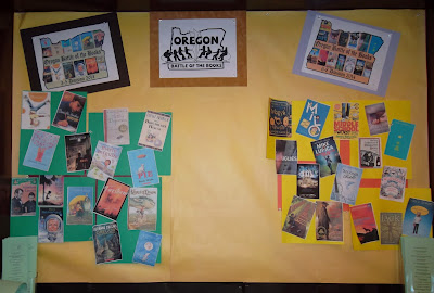 Poster board displaying logos: Oregon Battle of the Books, third- to fifth-grade and sixth- to eighth-grade divisions, with cover reproductions of featured titles