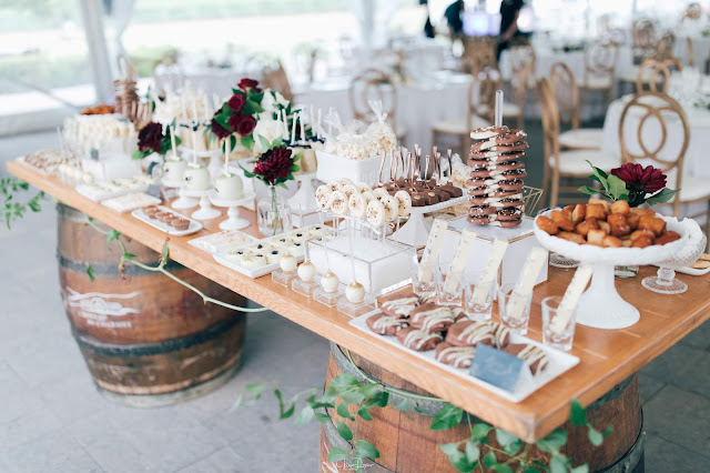 Niagara Wedding Planner - A Divine Affair - Meaghan and Scott - Photo by Marco Roxas Photography. Wedding ceremony and reception at Chateau des Charmes Winery in Niagara on the Lake. Navy Blue and Burgundy colours with Gold accents in the wedding attire and decor. Sweets table on wine barrels by Sweet Bash Co.