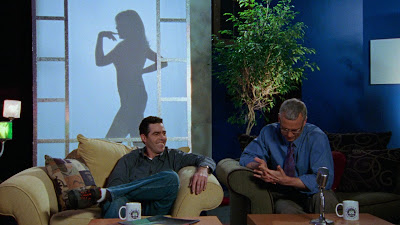 Audrey posing sexily behind a sillhouette screen, finger touched to her mouth as Adam fucking Corolla laughs and Dr. Drew looks down awkwardly