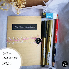 A box of stationery with gold markers