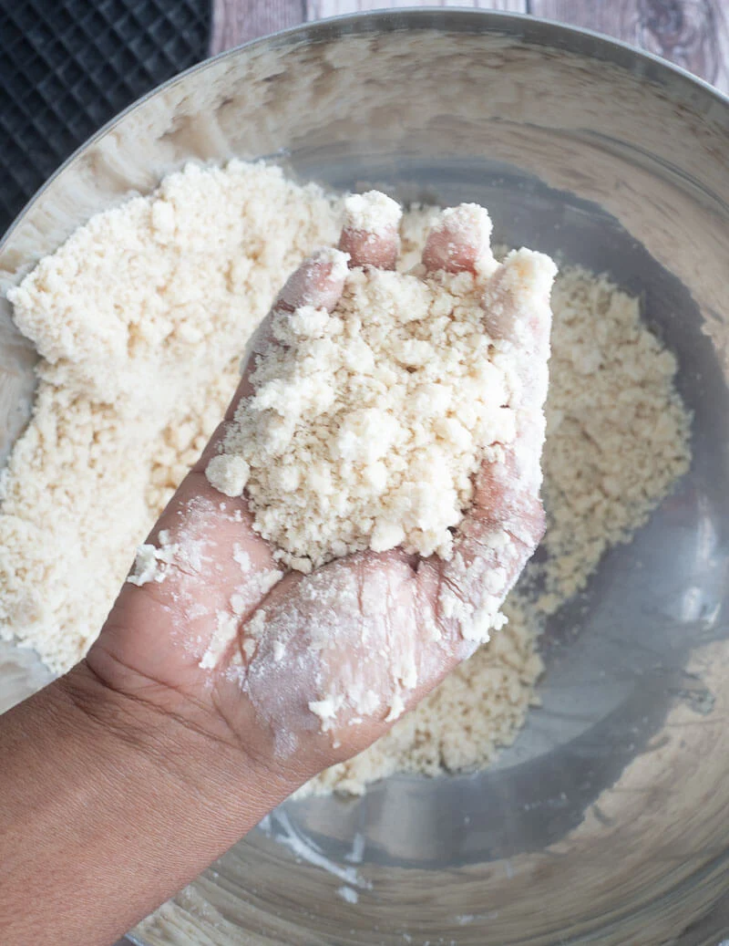 A handful of flour and butter mixture showing he crumble results of the rub-in method.